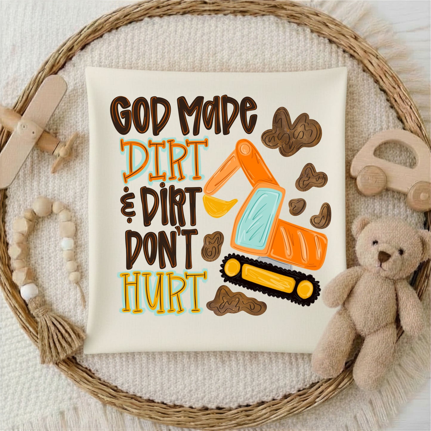 Children's poster with excavator and text 'God made dirt and dirt don't hurt' on a textured surface with toys.