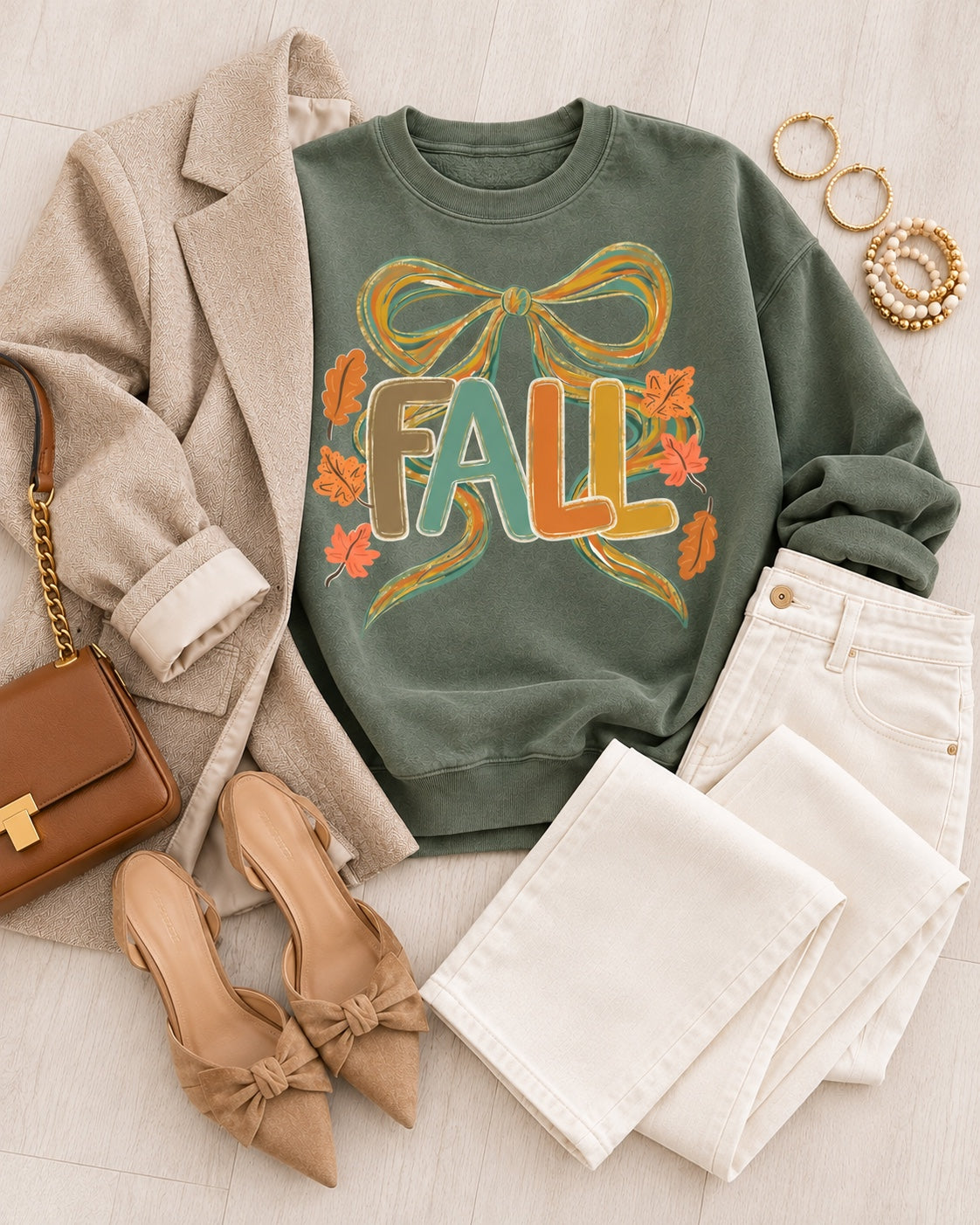 Fall bow graphic sweatshirt flat lay with blazer cream trousers and accessories