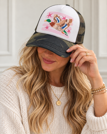 Model wearing pink mallard camo trucker hat
