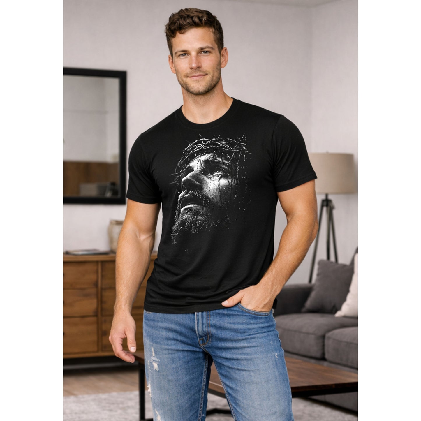 Man wearing a black t-shirt with a graphic design in a living room setting