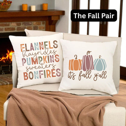 The Fall Pair | A pair of Fall themed throw pillows sitting on a chair in a living room decorated for fall