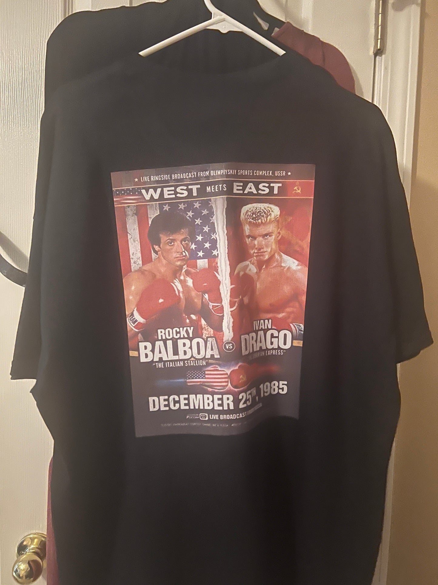 Black t-shirt with a boxing match poster design on a white background