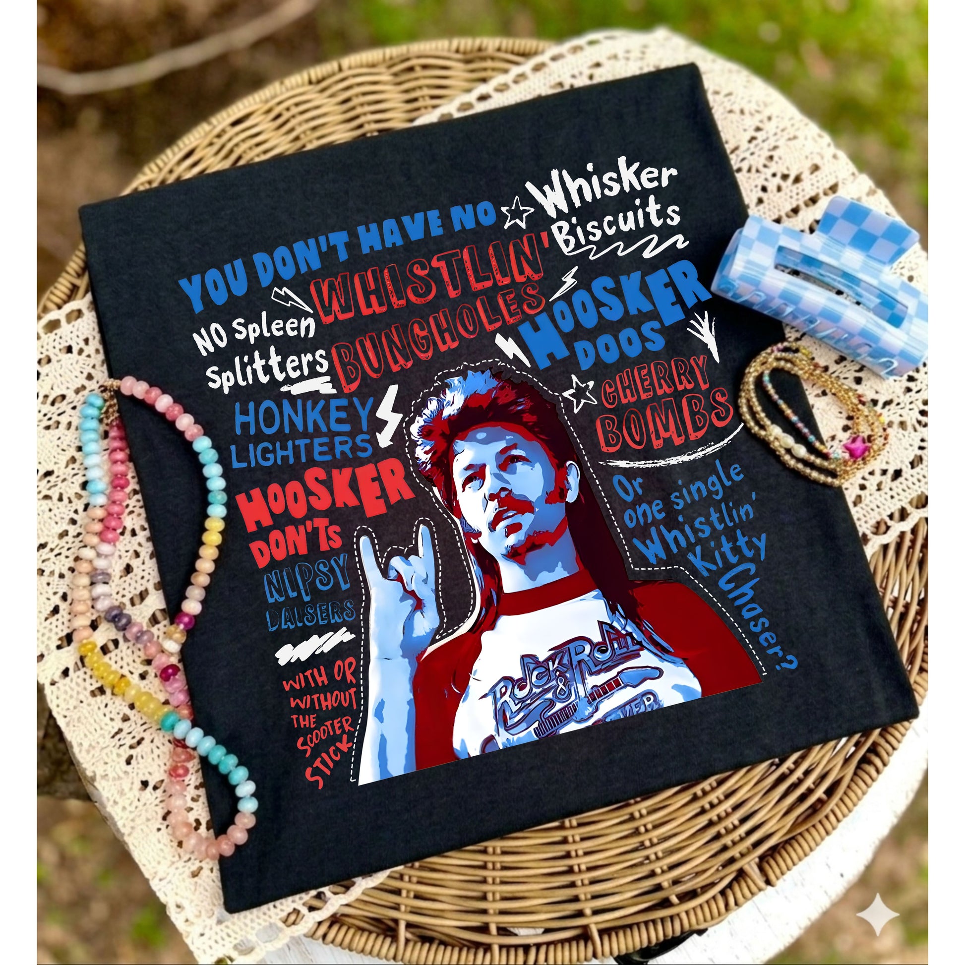 Black pillow with colorful text and graphic design on a woven surface