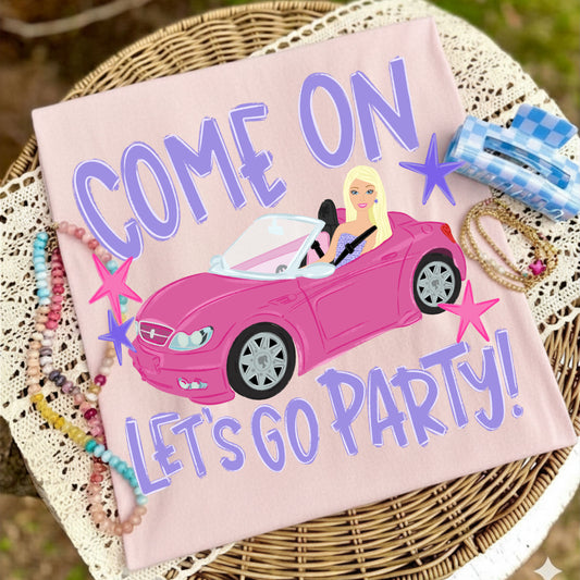 Pink t-shirt with a car graphic and text 'COME ON LET'S GO PARTY!' on a woven surface.