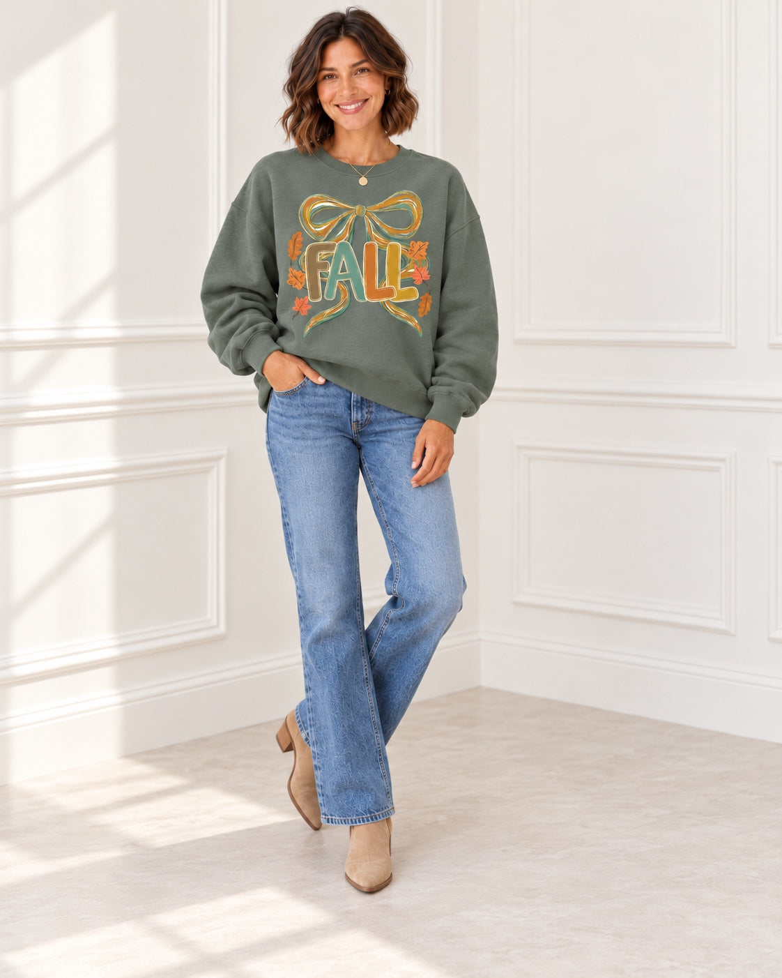 Green Fall bow sweatshirt styled casually with jeans and ankle boots