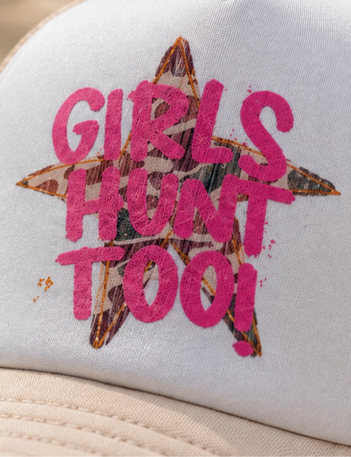 Close-up pink Girls Hunt Too graphic featuring camouflage-pattern star