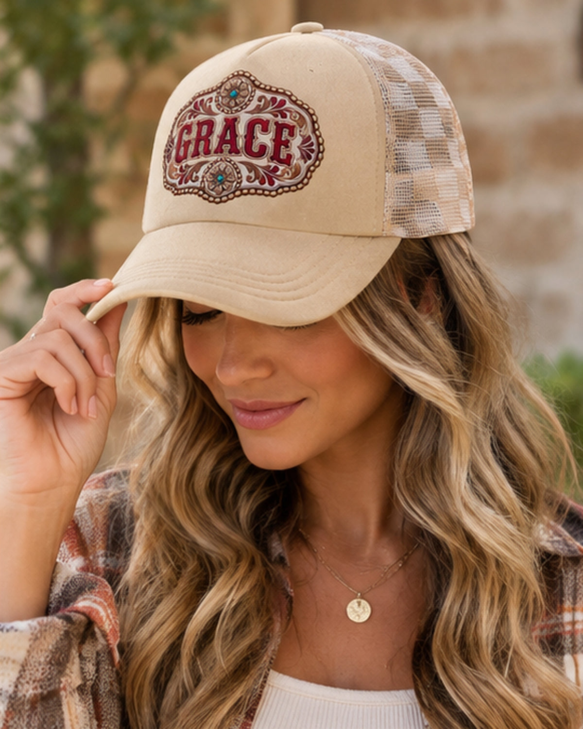 Woman wearing tan Grace snapback hat with beige checked mesh back