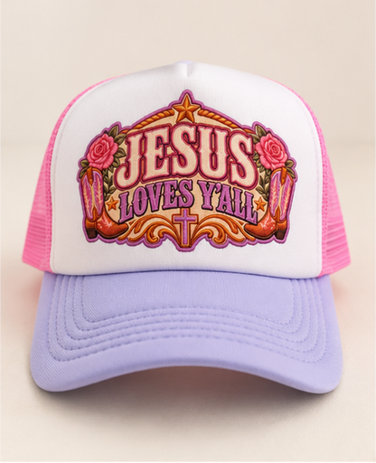 Jesus Loves Y'all trucker hat with white foam front lavender bill bright pink mesh and western floral lettering