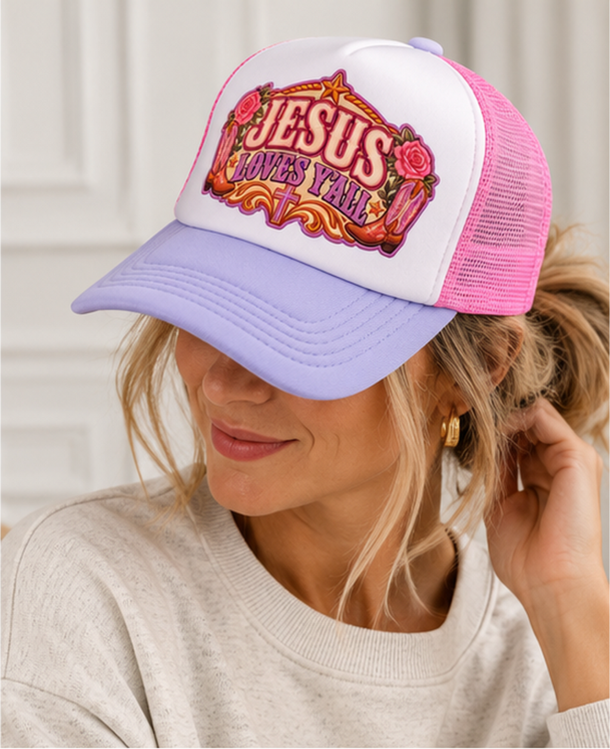 Model wearing Jesus Loves Y'all lavender and pink trucker snapback